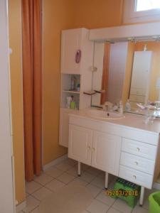 une salle de bain avec un lavabo et un miroir dans l'établissement aldaro, à La Celle-sous-Gouzon