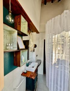 a bathroom with a sink and a shower at L'Antica Nicchia - Centro Storico in San Gimignano +13 photos