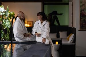a man and a woman sitting on a table with drinks at Hôtel & SPA Le Chêne Vert in Brive-la-Gaillarde +78 photos