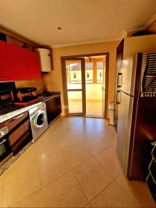 a kitchen with a stainless steel refrigerator and a dishwasher at Nobilium in Meknès