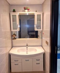 a bathroom with a sink and a mirror at Nobilium in Meknès