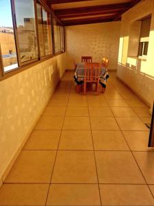 a room with a table and chairs on a tiled floor at Nobilium in Meknès +7 photos