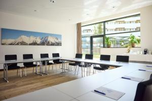 a conference room with a long table and chairs at ROBINSON Fieberbrunn - Adults only in Fieberbrunn +98 photos