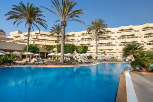 a large swimming pool in front of a hotel at Barceló Corralejo Bay - Adults Only in Corralejo