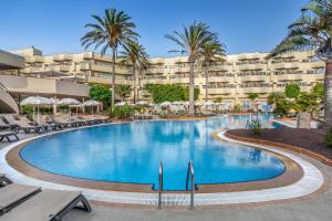 a large swimming pool in front of a resort at Barceló Corralejo Bay - Adults Only in Corralejo