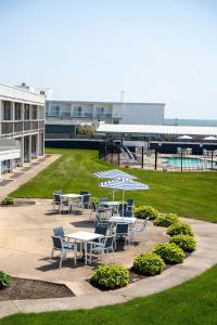 a group of tables and chairs on a lawn at Surf & Sand Beach Motel in South Yarmouth