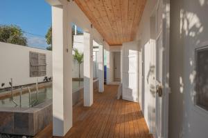 a hallway with white walls and a wooden ceiling at La Kazaka Terre Sainte in Saint-Pierre