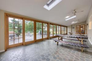 a large room with a bench and large windows at Blue Ribbon Homestead in Biglerville
