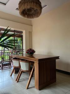 a dining room with a wooden table and chairs at Kivuli Inn in Moshi