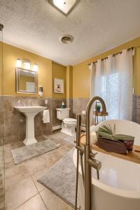 a bathroom with a tub and a sink at Blue Ribbon Homestead in Biglerville +80 photos