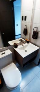 a bathroom with a sink and a toilet and a mirror at Tu lugar ideal en el sector ideal de Santiago in Santiago
