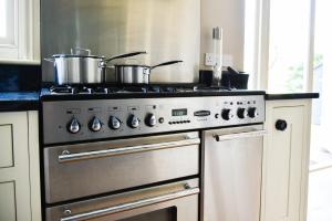 a kitchen with two pots on top of a stove at White Fox House in Burgess Hill