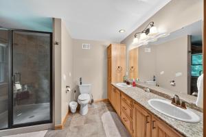 a bathroom with two sinks and a shower at Forest Glade in Sturgis +69 photos