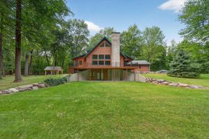 a home with a large yard with a house at Forest Glade in Sturgis