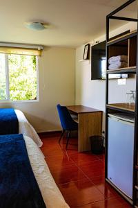 a room with a bed and a desk and a table at Refugio Ecológico Arequipa in Arequipa