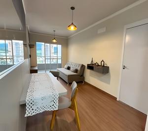 a living room with a table and a couch at Rose Prime Loft – Executive Apartment in Extrema in Extrema