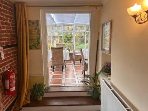 an open door to a patio with a table and chairs at The Beaumont in Sittingbourne