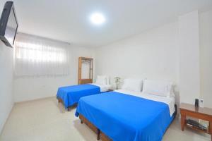 Postel nebo postele na pokoji v ubytování Hotel Getsemaní BGA + 24 fotografií