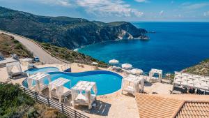 an aerial view of a pool and the ocean at Petani Bay Hotel - Adults Only in Vovikes