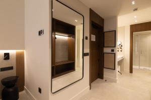 a bathroom with a large mirror on the wall at Moontels Colón in Valencia +90 photos