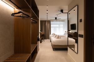 a hotel room with two beds and a mirror at Moontels Colón in Valencia