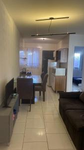 a living room and kitchen with a table and a couch at Casa com garagem 4 pessoas in Ponta Grossa