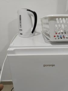 a white appliance sitting on top of a refrigerator at Pod kestenom in Vršac