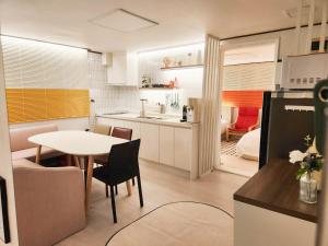 a kitchen with a table and a dining room at New Sale 프리미엄 대치 강남 The Premium Daechi Gangnam in Seoul +39 photos