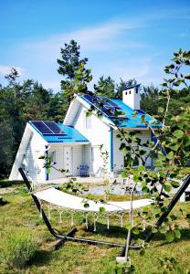 a house with a blue roof with a solar panel at Solarna Eko Vila in Divčibare