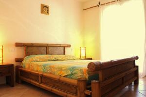 En eller flere senge i et værelse på Perla Del Porto Apartments