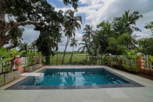 a swimming pool in the backyard of a house at The Village Casa in Aldona