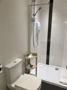a white bathroom with a shower and a toilet at NELL GWYNN HOUSE - Hotel Room Style POD Room 61 in London