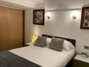 a bedroom with a white bed with two pillows at NELL GWYNN HOUSE - Hotel Room Style POD Room 61 in London