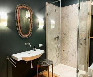 a bathroom with a sink and a shower at Riverside Architect-Designed Garden Apartment in Süderstapel