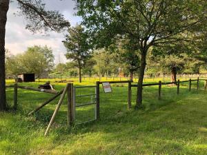a fence with a sign on it in a field at Bungalow "CONFORT" PUY duFOU 2CH-5pers 720FA in La Boissière-de-Montaigu