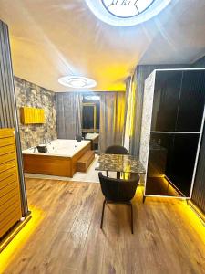 a large bathroom with a tub and a table at Taksim Luxury Arcadia Hotel in Istanbul