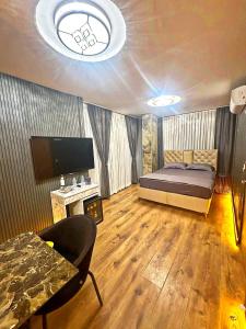 a bedroom with a bed and a tv and a couch at Taksim Luxury Arcadia Hotel in Istanbul +8 photos