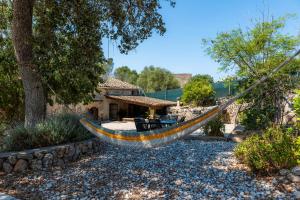 a hammock in the yard of a house at Can Gallot De Punxuat - Pool in Algaida