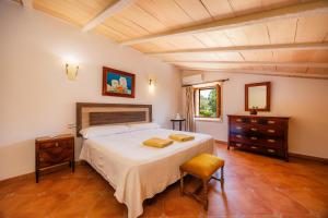 a bedroom with a large bed and a wooden ceiling at Can Gallot De Punxuat - Pool in Algaida +37 photos