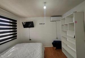 Ένα ή περισσότερα κρεβάτια σε δωμάτιο στο Habitaciones en Curico