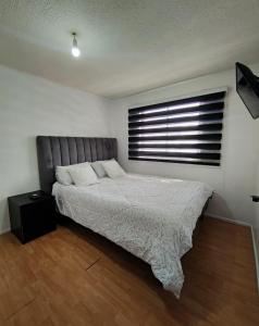 Ένα ή περισσότερα κρεβάτια σε δωμάτιο στο Habitaciones en Curico