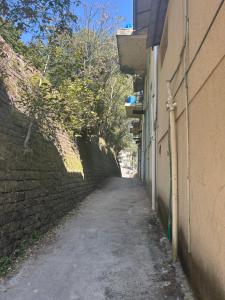 an alley between a building and a brick wall at Aqua pura Lodges By Ansar Qureshi in Murree +14 photos