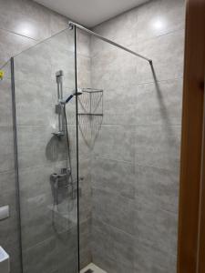 a bathroom with a shower with a glass door at The valley 309 in Nariani +16 photos