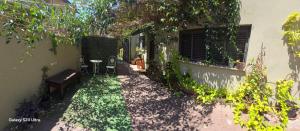 a garden in a house with a table and chairs at B&B Amit 18 minutes from airport in Petaẖ Tiqwa