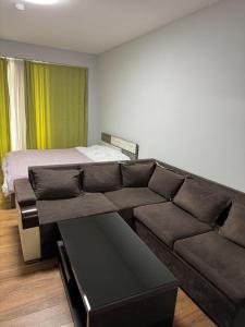 a living room with a couch and a bed at The valley 309 in Nariani