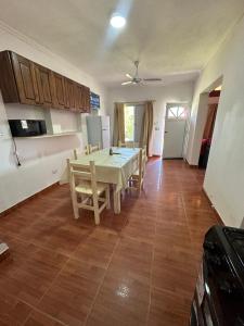 a kitchen and dining room with a table and chairs at Cabañas & Apart Yki Shamuaika in Capilla del Monte +151 photos