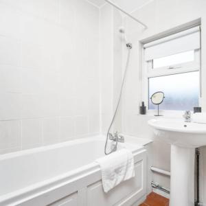 a white bathroom with a tub and a sink at Three Bedroom House - City Centre - Garden - Parking 12W in Birmingham