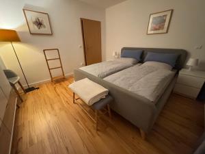 a bedroom with a large bed and a chair at Nest,Ruhe und Erholung in Castrop-Rauxel