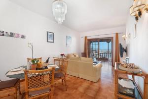 a living room with a table and a dining room at Cozy apartment with sea view - 70 m² in Acantilado de los Gigantes