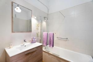 a white bathroom with a sink and a shower at Cozy apartment with sea view - 70 m² in Acantilado de los Gigantes +28 photos